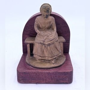 Vintage heavy cast iron bookend of a woman sewing